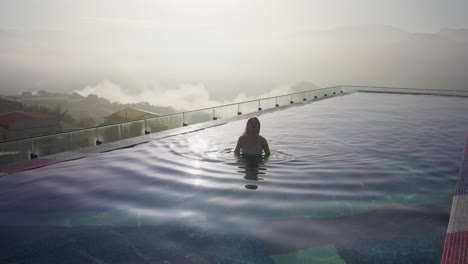 Sexy-Asian-woman-relaxing-in-infinity-pool-of-luxury-hotel-in-Taiwan