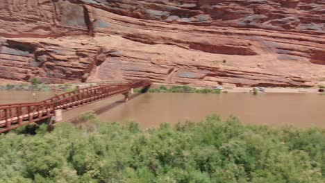 Pan-Left-over-red-bridge-over-Colorado-River-in-the-United-States-in-the-canyon