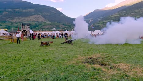 Firing-of-a-cannon-during-an-reenactment-of-the-Calvin-Battle-at-the-South-Tyrolean-Medieval-Games-in-Schluderns---Sluderno,-South-Tyrol,-Italy