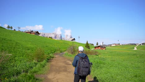 Man-with-a-backpack-on-a-footpath-ready-to-hike-in-Alpe-di-Siusi