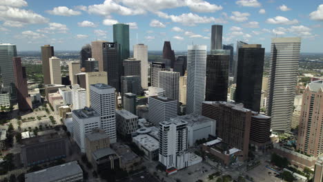 Aerial-view-orbittng-the-downtown-of-Houston,-partly-sunny-day-in-Texas,-USA