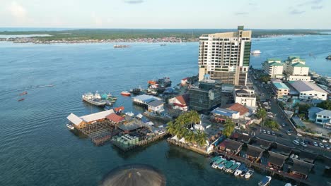 Aerial-establishing-shot-of-the-seafest-square-with-a-busy-waterway-in-semporna