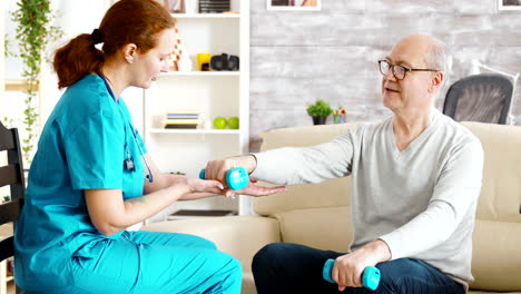 Female-nurse-helps-an-old-man-to-make-his-morning-exercises