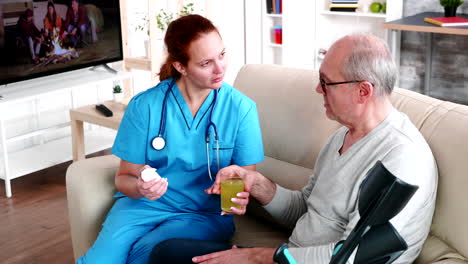 Doctor-in-nursing-home-giving-old-man-pills