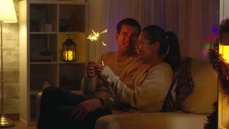 Cheerful-husband-and-his-wife-playing-with-fireworks