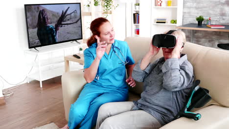 Female-caregiver-helping-elderly-woman-to-experience-virtual-reality-in-retirement-home
