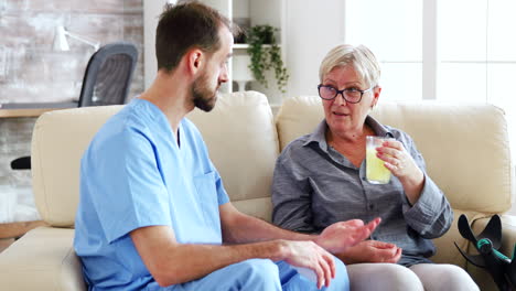 Senior-woman-in-nursing-home-talking-with-male-doctor