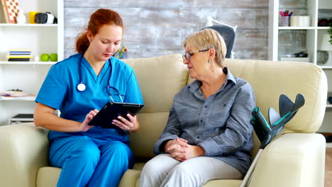 Female-doctor-holding-tablet-computer-in-nursing-home