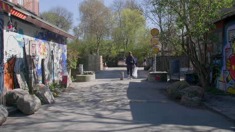 Urban-walkway-with-vibrant-street-art-in-Christiania,-Copenhagen