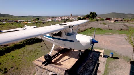 Slow-4K-drone-revealing-the-small-rural-village-of-Alcublas-with-an-old-Cessna-172-as-exhibition,-Spain