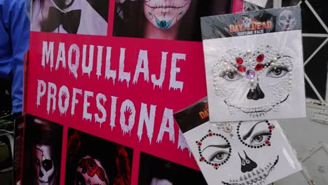 Signage-at-face-painting-kiosk-for-Day-of-the-Dead-celebration,-Mexico