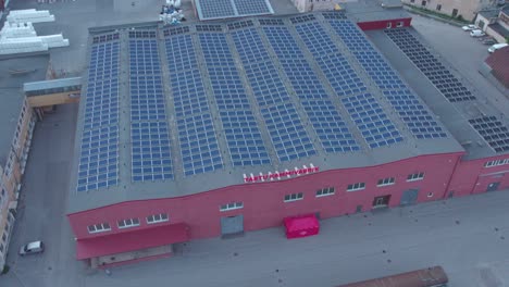 Drone-shot-of-Tartu-Kammivabrik-covered-with-solar-panels-in-Karlova-Tartu-Estonia