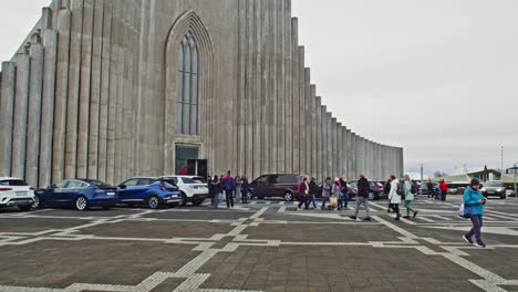 Tourists-walking-around-square-in-front-of-Hallgrímskirkja-church-in-Reykjavik,-Iceland