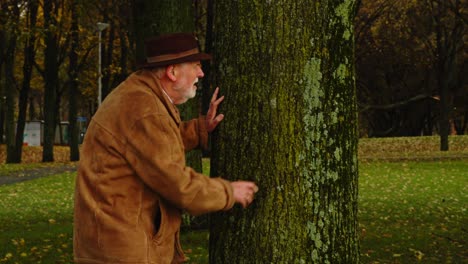 Private-investigator-hiding-behind-a-tree-and-looking-at-someone-off-screen