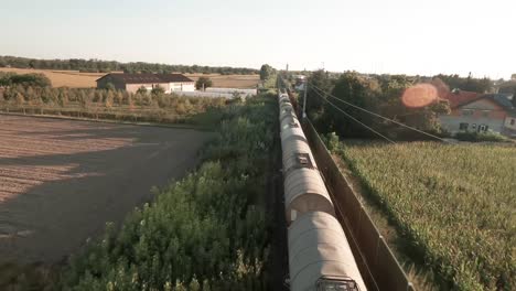 Drone-captures-train-from-close-range,-then-ascends-for-an-aerial-view