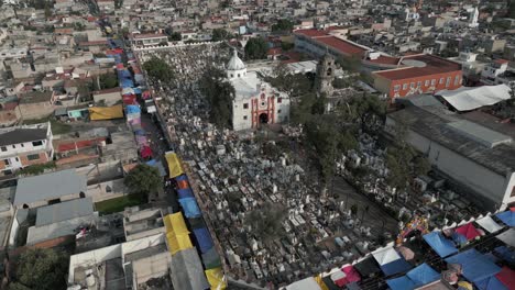 Aerial-descent-to-St-Andrew-church-yard-cemetery-in-Mixquic,-Mexico