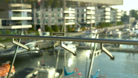 Panning-View-Of-Glass-Balustrades-with-marina-in-backgound