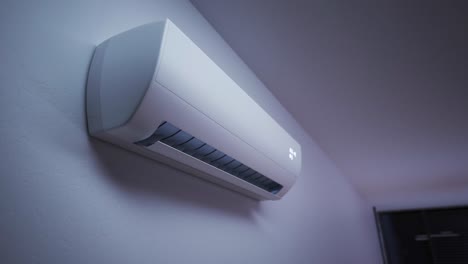Modern,-slick,-indoor-air-conditioner-unit-on-the-wall.-The-ventilation-equipment-cooling-the-hot-air-providing-perfect,-healthy-climate.-Camera-slowly-and-smoothly-pans-around-it.