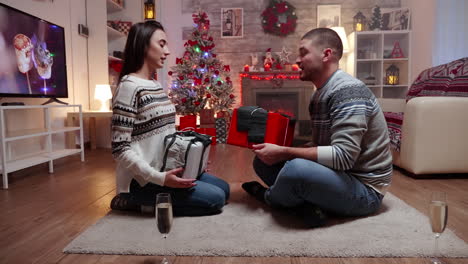 Zoom-in-shot-of-couple-exchanging-gifts
