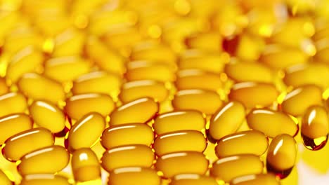 Yellow-translucent-gel-capsules-with-omega-3,-vitamin-D,-fish-oil-or-cod-liver-oil-falling-on-white-reflective-surface.-Pile-of-vitamin-pills-supplement.-Healthy-diet-concept