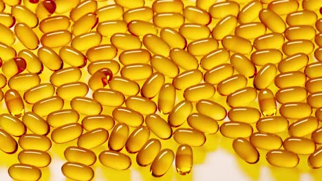 Yellow-translucent-gel-capsules-with-omega-3,-vitamin-D,-fish-oil-or-cod-liver-oil-falling-on-white-reflective-surface.-Pile-of-vitamin-pills-supplement.-Healthy-diet-concept
