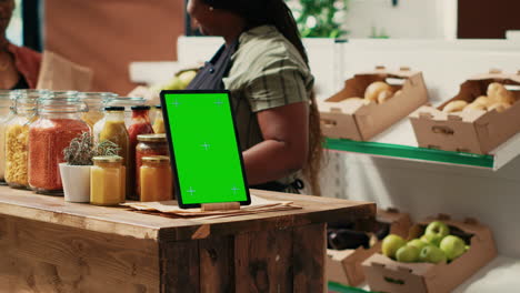 Device-showing-greenscreen-template-at-local-supermarket