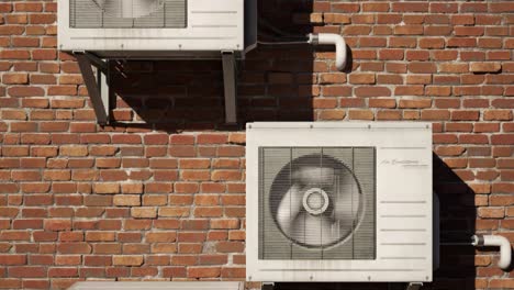Multiple-old,-rusty-outdoor-air-conditioner-units-on-the-brick-wall.-Camera-moves-upwards-in-endless,-seamless-loop.-Many-units-providing-fresh,-cool-air-to-the-citizens.-City-overheat-as-a-result.