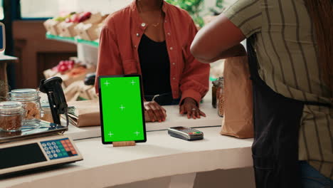 Tablet-showing-isolated-greenscreen-display-at-cash-register