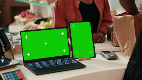 Laptop-and-tablet-running-greenscreen-layout-in-local-store