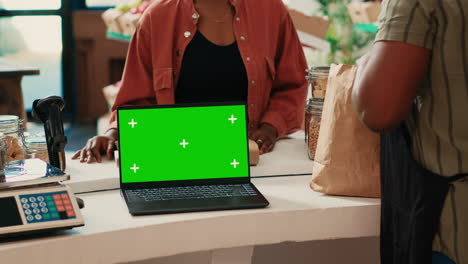 Client-buying-produce-next-to-greenscreen-on-laptop