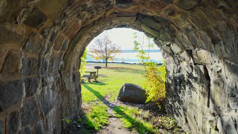 A-walk-through-an-old-stone-tunnel-on-a-sunny-day-in-a-park-in-New-Jersey