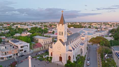 Aerial-establishing-shot-of-Cathedral-San-Pedro-Apostol-during-golden-sunset-on-Dominican-Republic---rising-drone-shot
