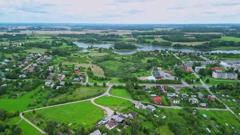 Drone-video.-Rural-houses,-forest-and-green-fields