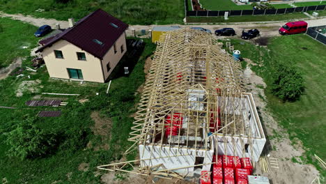 Aerial-view-of-the-construction-of-a-roof-with-wooden-trusses