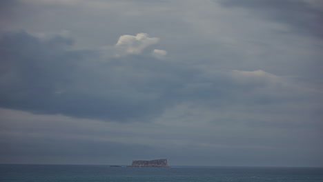 Timelapse-of-a-dramatic-sky-at-the-sea-a-small-island-is-on-the-horizon
