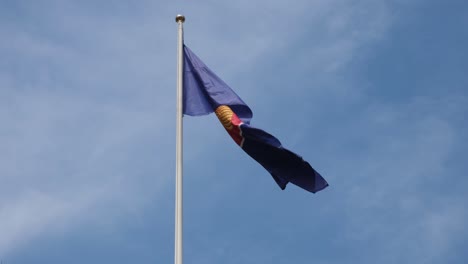 ASEAN-Flag-flying-to-the-right-with-some-wind-with-the-blue-sky-and-some-thin-clouds,-Southeast-Asia