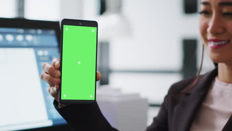 Architect-holding-smartphone-with-greenscreen-layout