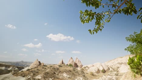 Distant-horse-riders-fairy-tent-rock-formations-red-valley-Cappadoccia