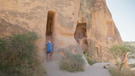Female-hiker-explores-rock-cave-homes-Red-valley-trail-Cappadoccia
