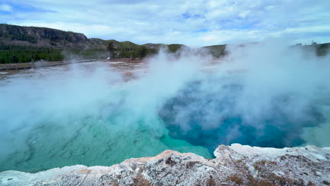 Excelsior-Geyser-Crater-Midway-Geyser-Basin-Grand-Prismatic-Spring-Yellowstone-National-Park-Old-Faithful-Grand-loop-scenic-Wyoming-Idaho-mist-steam-thermal-colorful-aqua-blue-morning-cinematic-still