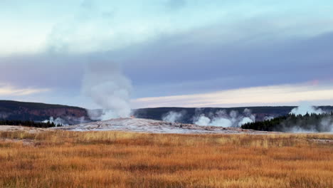 West-Yellowstone-Old-Faithful-National-Park-entrance-Grand-loop-geysers-scenic-landscape-Wyoming-Idaho-mist-steam-thermal-Grand-prismatic-colorful-yellow-sunset-tall-grass-cinematic-slowly-pan-left