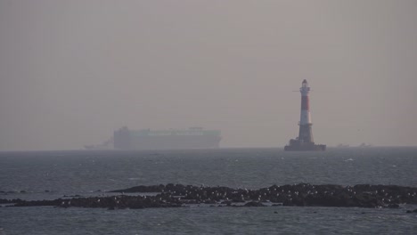 Ship-moving-slowly-towards-lighthouse