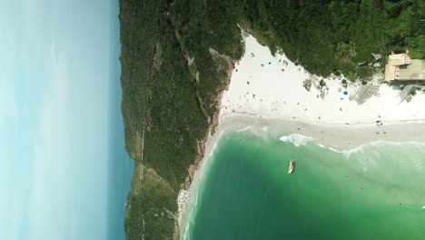 Vertical-video-of-Aerial-of-beach-paradise-with-soft-sand-near-Rio-de-Janeiro-in-Brazil,-South-America
