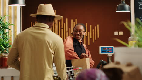 African-american-seller-working-at-supermarket-cash-register-counter