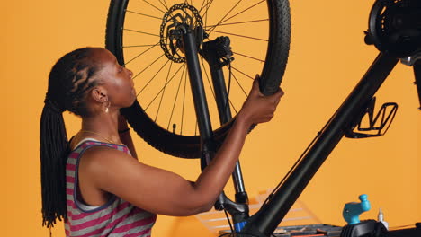 Specialist-detaching-wheel-from-bicycle-on-repair-stand