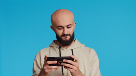 Middle-eastern-person-playing-mobile-video-games-on-app