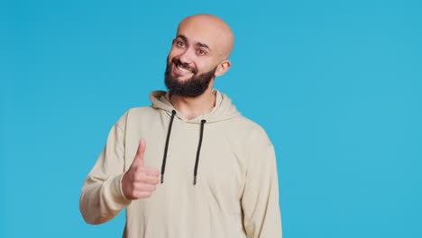 Middle-eastern-person-does-thumbs-up-sign-on-camera