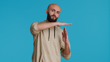 Middle-eastern-person-doing-timeout-gesture-on-camera