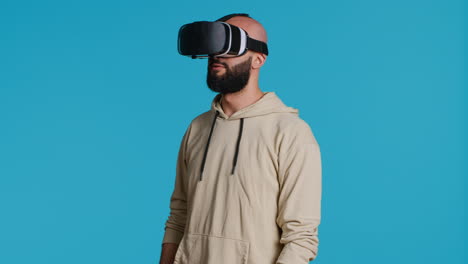 Middle-eastern-adult-using-virtual-reality-glasses-in-studio