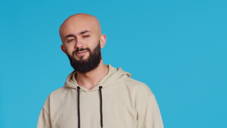 Arab-male-model-doing-no-symbol-on-blue-backdrop